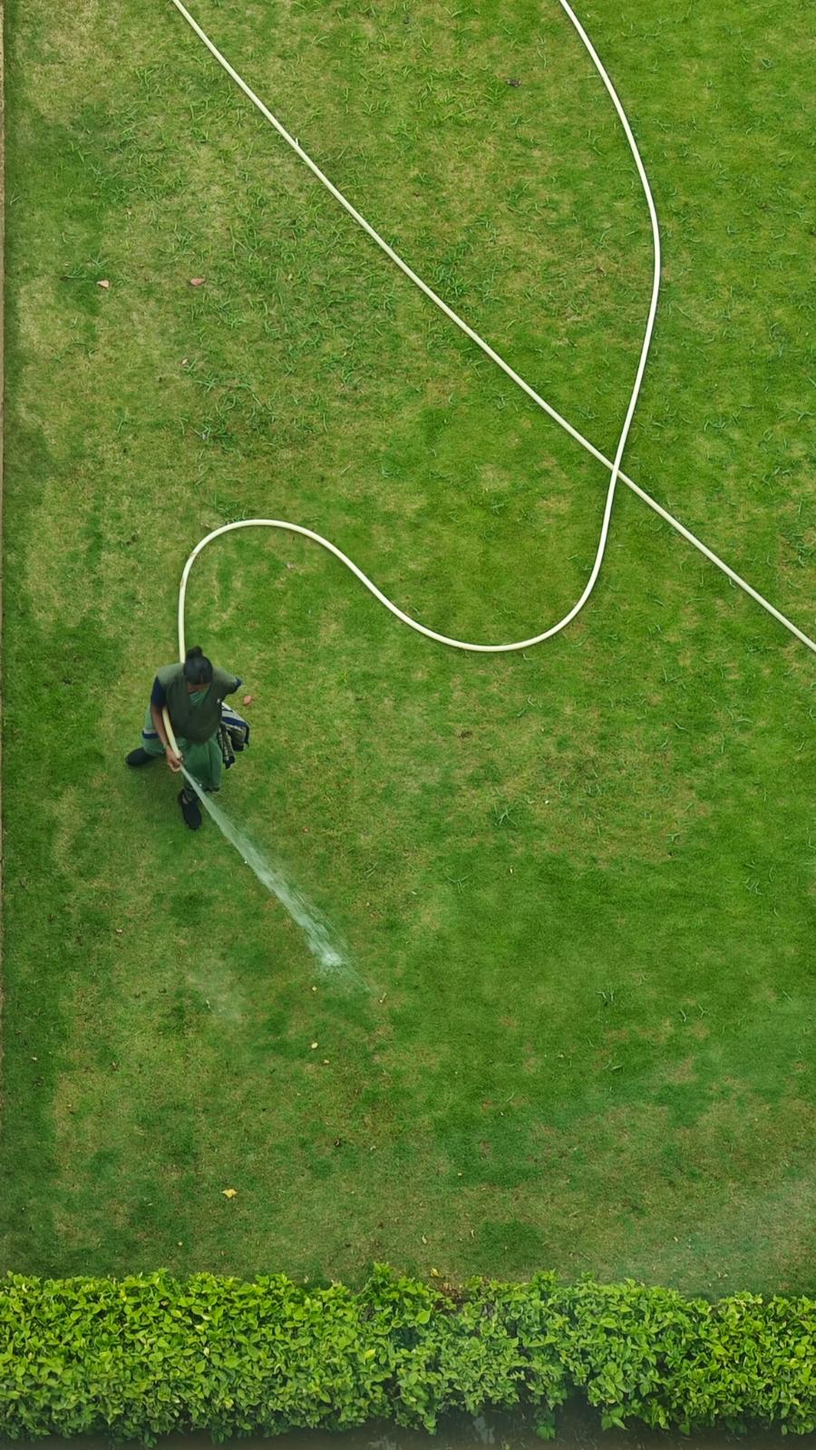 Lawn care technician applying a seasonal treatment to a lawn